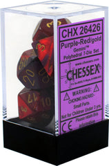 Set of polyhedral dice with purple, red, and gold colors in a clear box, featuring Chessex branding. | Tacoma Games